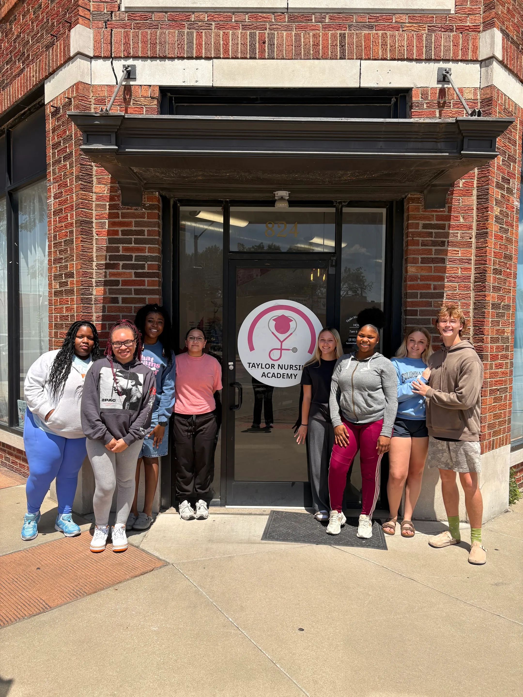 A group outside the Taylor Nursing Academy entrance in Grandview